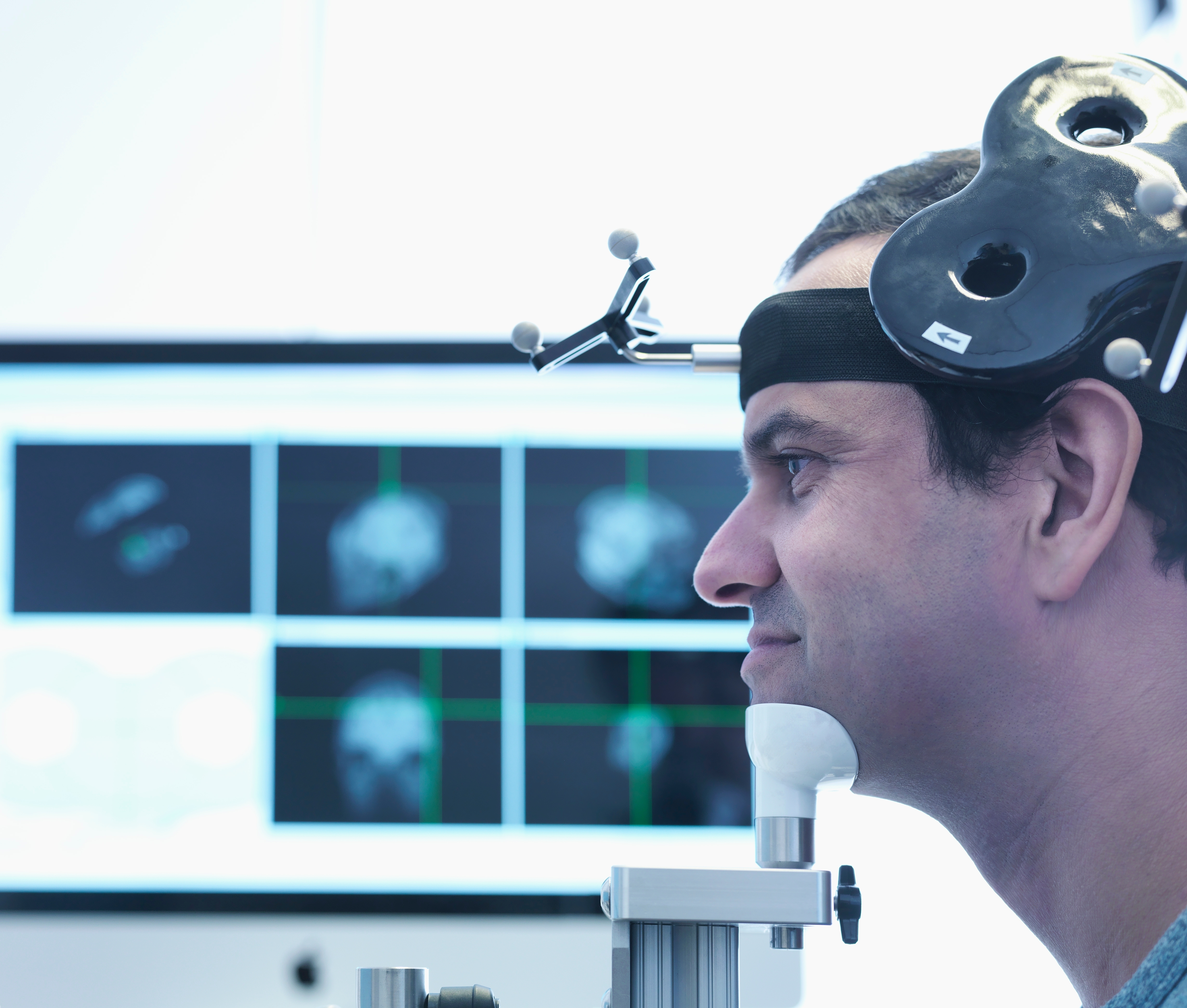 Psychiatrist reviewing TMS therapy safety screening with patient before treatment